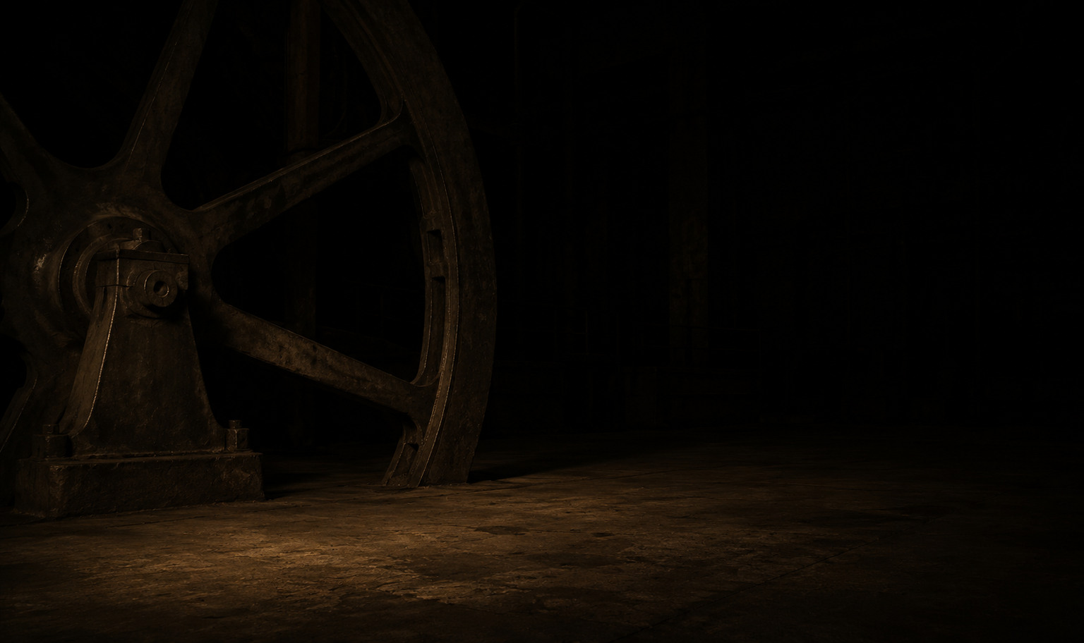 A colossal iron flywheel in an unlit hall, running off the top and left of the frame, its lower rim and base catching a weak amber light while the empty floor recedes into black